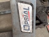 a sign on the side of a machine in a garage