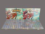 two pokemon cards are on display in a display case
