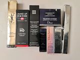 a lot of makeup products on a white table