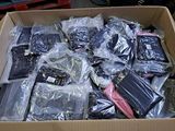 a cardboard box filled with assorted electronics and other items