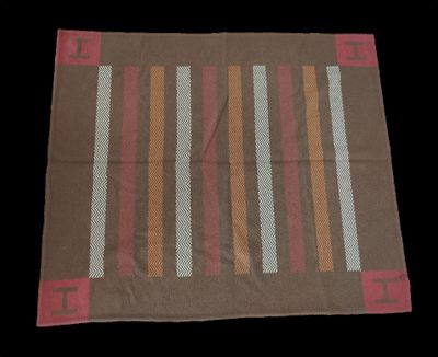 a close up of a brown and red rug on a black background