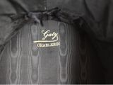 the jacket is black and has a gold logo on it