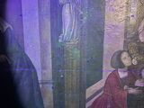 a painting of a woman kneeling in front of a painting of a man