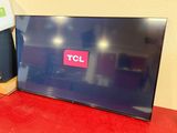 the television is sitting on a red table next to a box