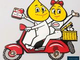 a picture of a couple of people on a scooter