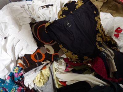 a pile of clothes that is sitting on the floor