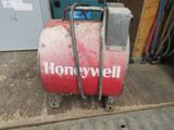 a red barrel with a sign on it sitting on the floor