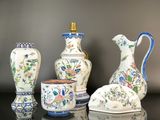 three vases sitting on a table with a vase in front of them