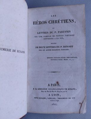 an open book on a blue surface with a black and white title