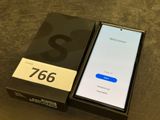 the box is open and the phone is sitting on the table