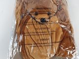a teddy bear that is wrapped in a plastic bag