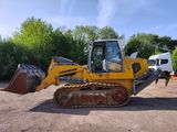 a yellow bulldozer that is parked in the dirt