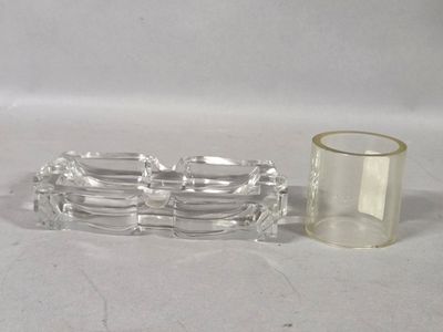 a glass candle holder and a glass candle holder on a table