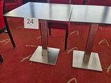 a table and chairs in a room with a red carpet
