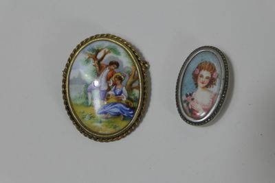 two miniature pictures of a woman and a child are displayed on a wall