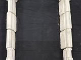 a pair of white marble columns on a black background