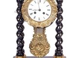 a black and gold clock sitting on top of a table