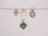 a close up of a necklace with four different charms on it