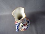 a small vase with a floral design on it