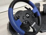 a steering wheel and a keyboard on a desk