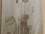 an old photo of a man dressed in native clothing