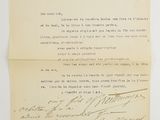 an old letter with handwriting on it sitting on top of a piece of paper