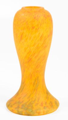 an orange vase sitting on a white surface with a white background