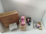a box of pink candles sitting on a shelf next to a box of brown candles