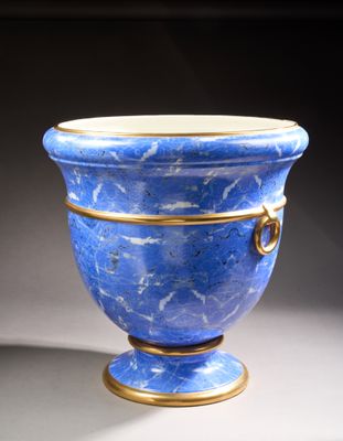 a blue vase that is sitting on a table
