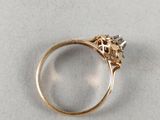 a close up of a gold ring with a diamond on it