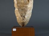 an image of a stone head on a wooden base