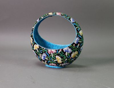 a small blue vase with a floral design on it