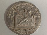 une pièce d'argent sur laquelle figure une silhouette ailée