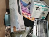 a cardboard box filled with items that include a wii controller