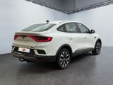 the rear end of a white suv parked in a garage