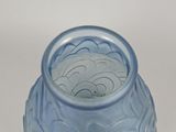 a blue glass vase with a pattern on it