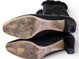 pair of black leather shoes with fur linings on top of each other