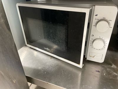 a microwave sitting on top of a metal counter