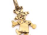 a close up of a gold charm with a clown face on it