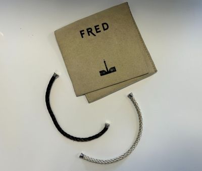 a brown box with a rope on it and the word fred written on it