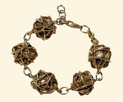 a bracelet made of metal balls on a chain