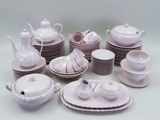 a lot of white dishes and cups on the table