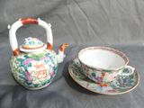 a tea pot and a cup on a table