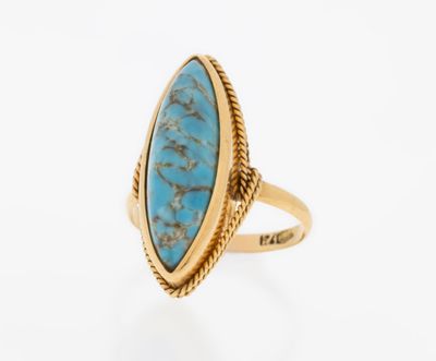 a gold ring with a turquoise stone in the center