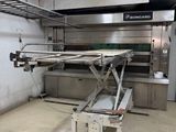 an image of a kitchen with a table in the middle of it