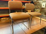two chairs that are sitting on a wooden table