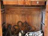 a wooden cabinet with a bunch of items inside of it