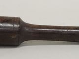 an old wooden hammer with a wooden handle on a white surface