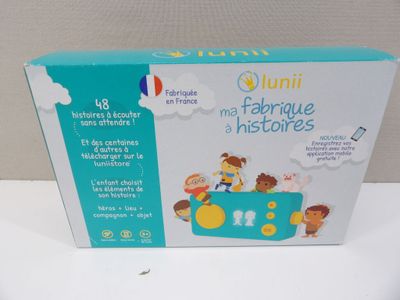 the box is open on a white surface with a picture of children in a toy car