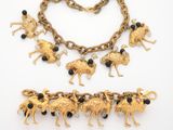 a close up of a necklace and bracelet on a white surface
